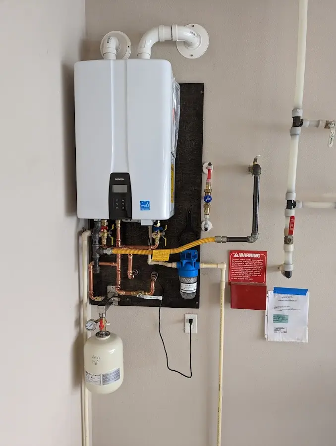 Professional plumber installing copper piping in a Aubrey home